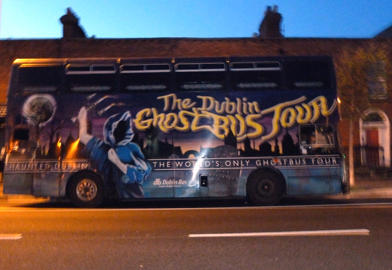 A photo of a bus at night with "The Dublin Ghostbus Tour, The world's only ghostbus tour" written on the side.