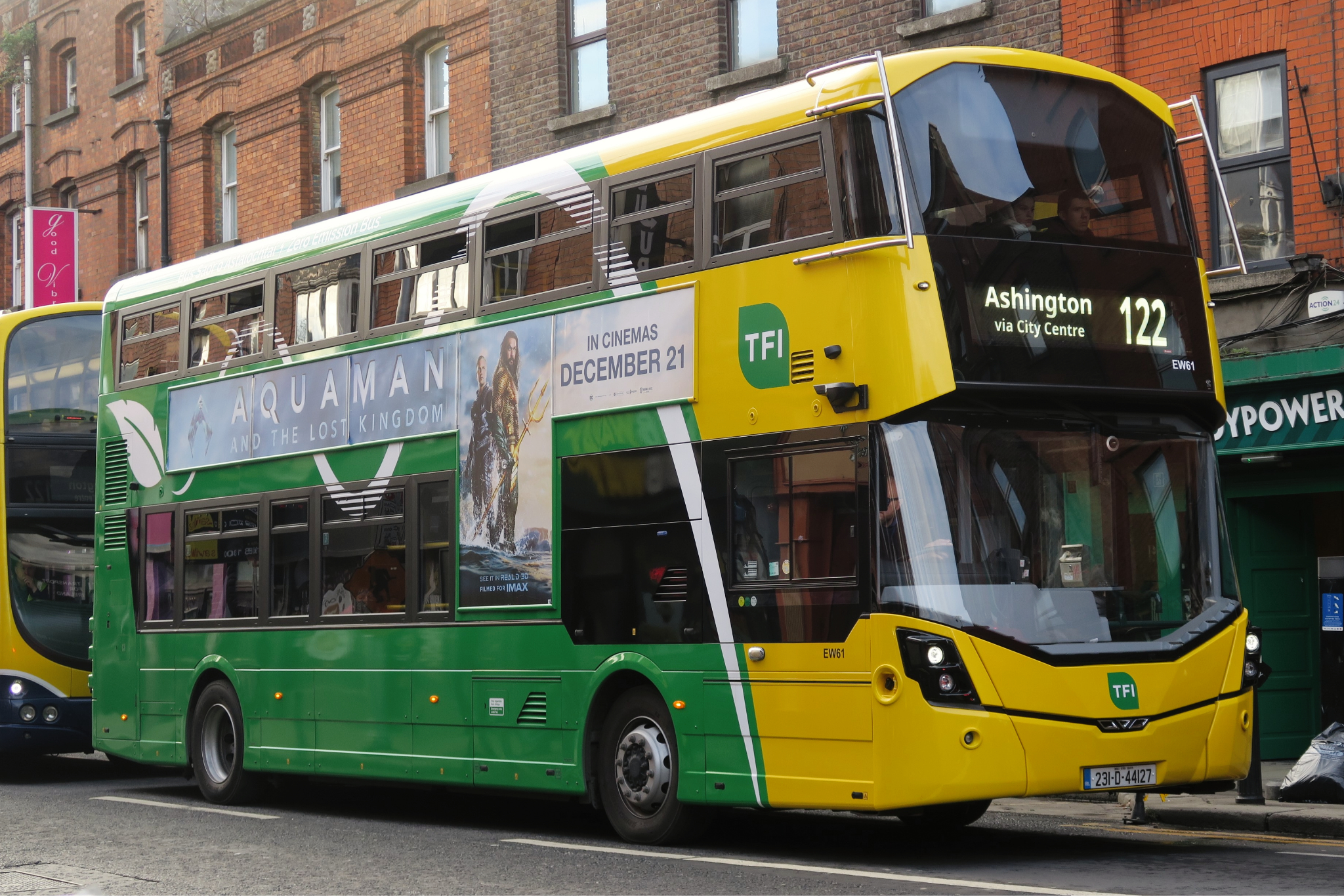 Photograph of a green and yellow city bus.