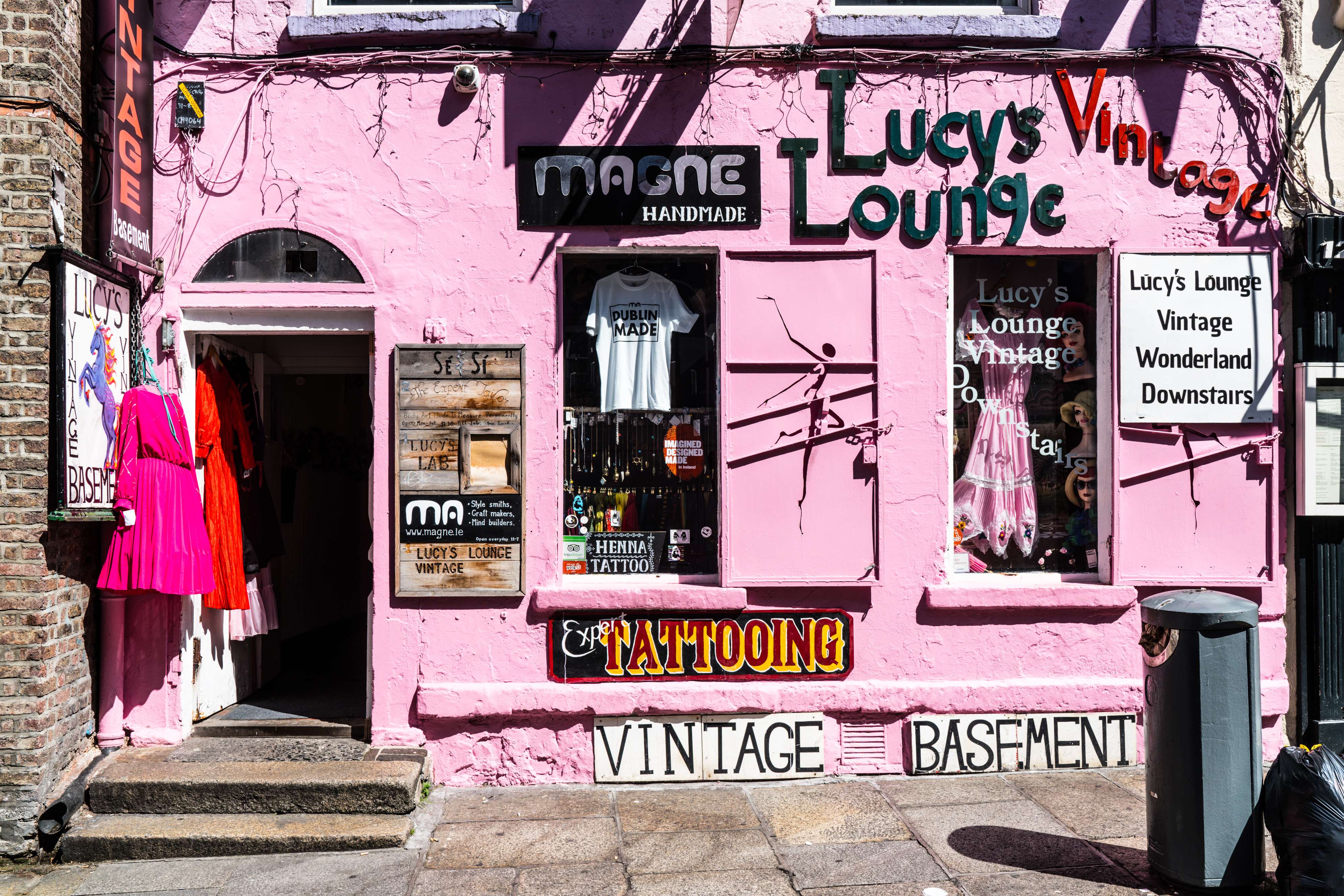 Photograph of a bright pink shop selling vintage clothing.