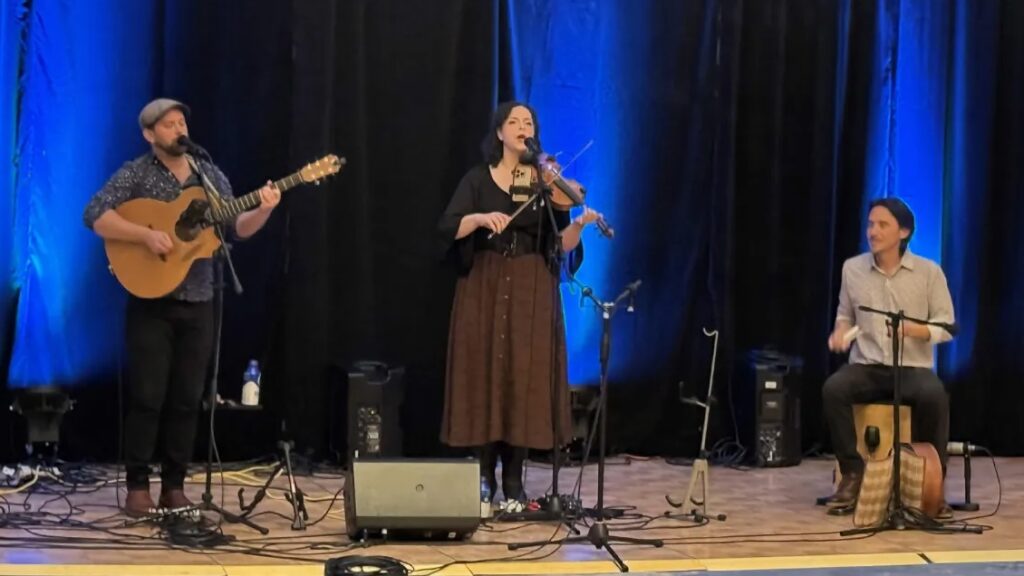 Three musicians on a stage. 
