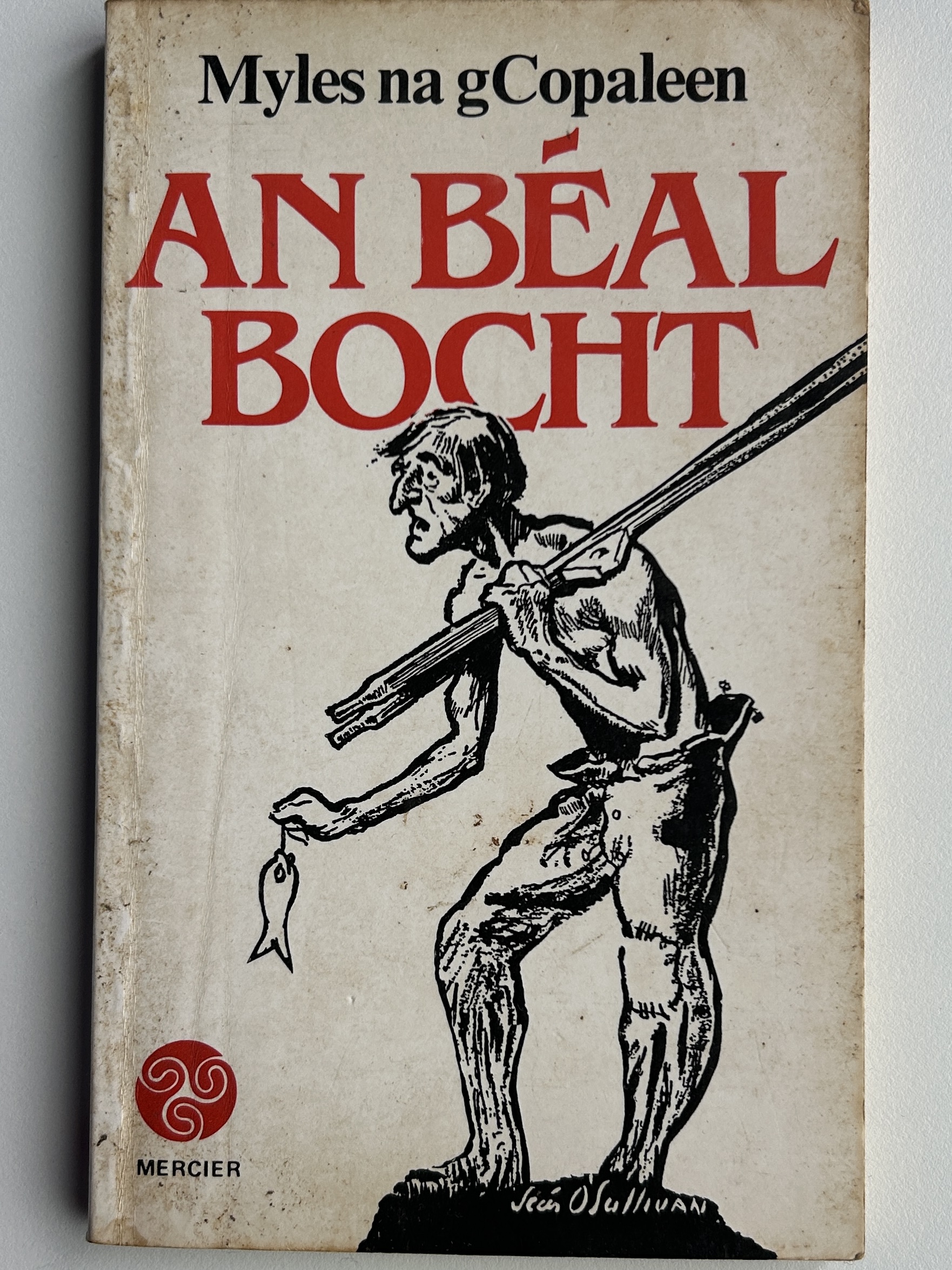 The cover of 'An béal bocht' by Myles na gCopaleen. The image on the cover is a low resolution pencil drawing of a young man in rags with a fish.